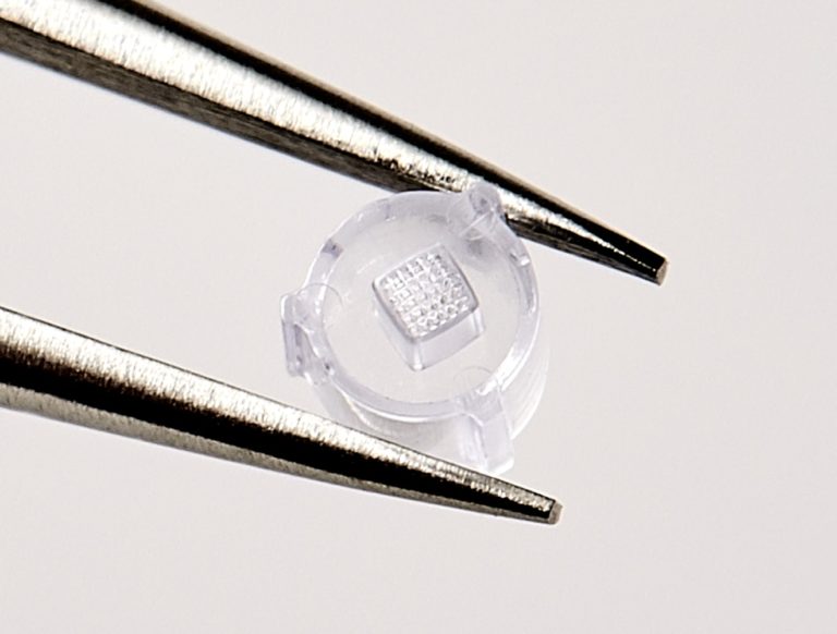 In Vitro medical device for reproductive support, held by tweezers, with thin wall molding and micro features by Isometric Micro Molding
